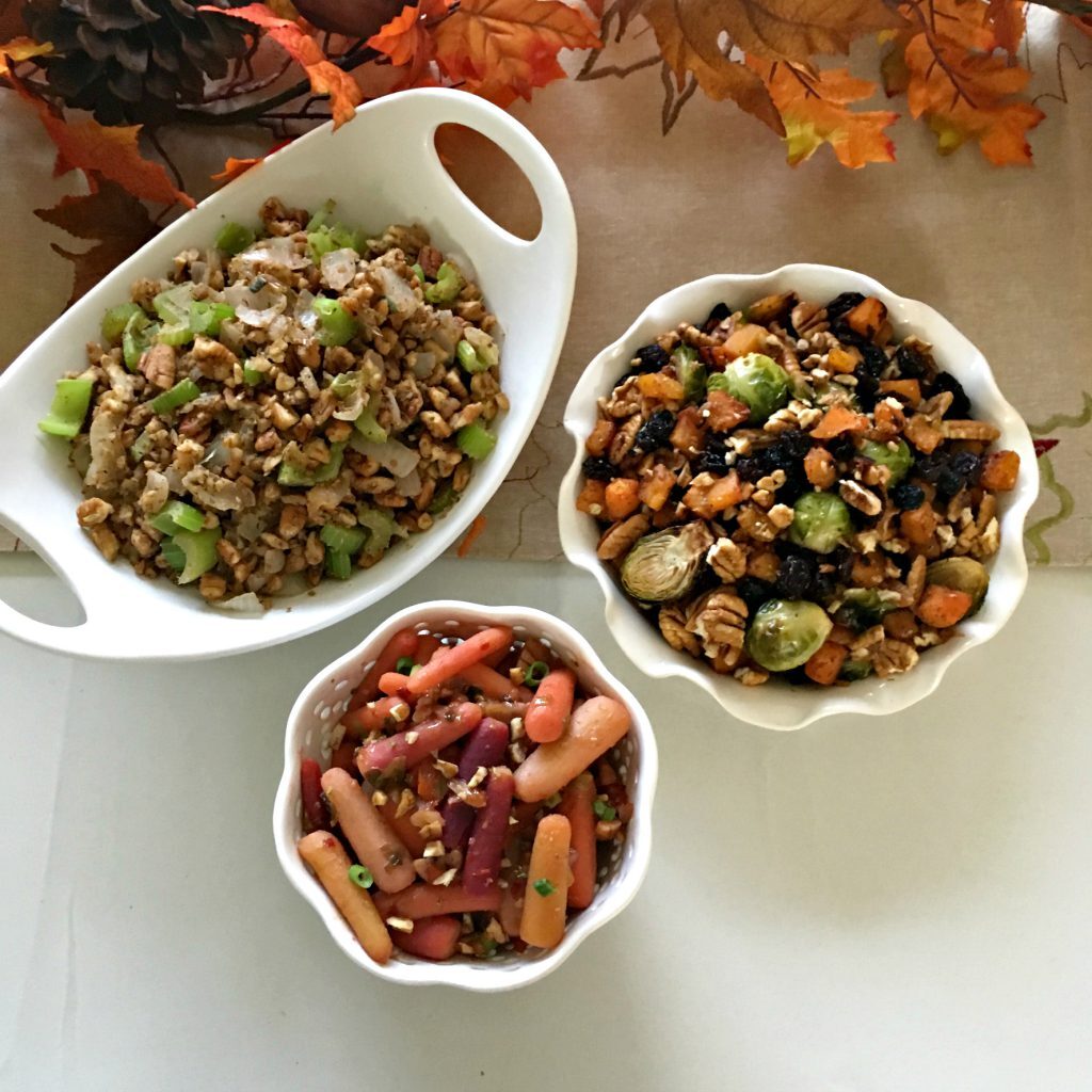 Three holiday side dishes in white serving dishes